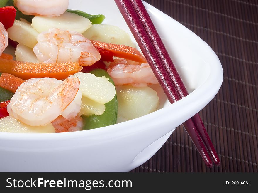 Asian salad in a white bowl with red chopsticks. Asian salad in a white bowl with red chopsticks.