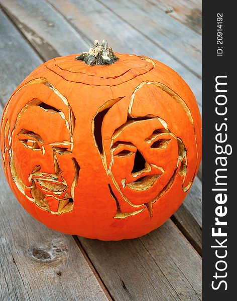 An artist carved a husband and wife's portrait into a pumpkin to create an extra-special and memorable Halloween. It sits on a wooden table. An artist carved a husband and wife's portrait into a pumpkin to create an extra-special and memorable Halloween. It sits on a wooden table.