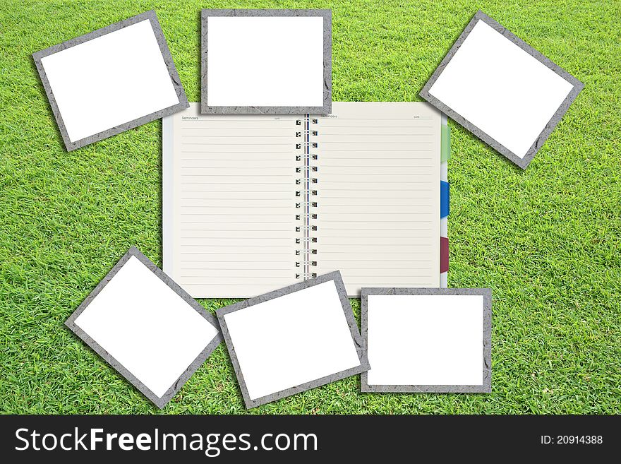 Blank photo frames and notepad on grass feild. Blank photo frames and notepad on grass feild.