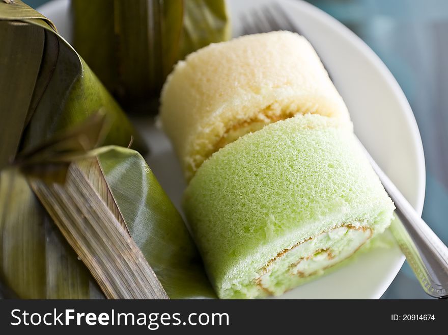 Thai desserts wrapped in banana leaves and steamed cooked with Bun stuffed with cream