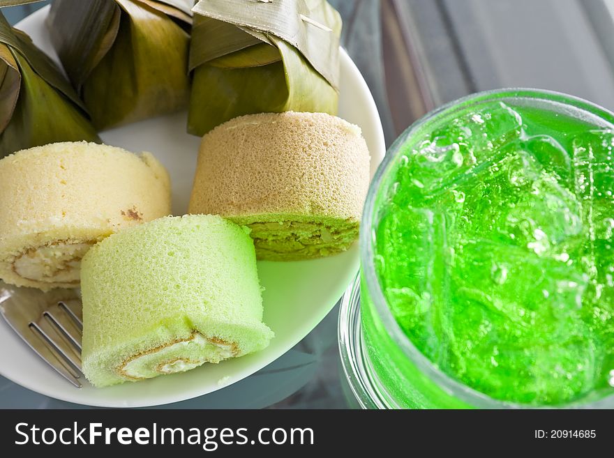 Thai desserts wrapped in banana leaves and steamed cooked with Bun stuffed with cream and aerated soft drink