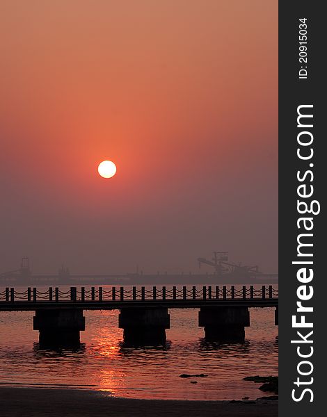 Sunrise Beach, prospect is a bridge, the background is a crane