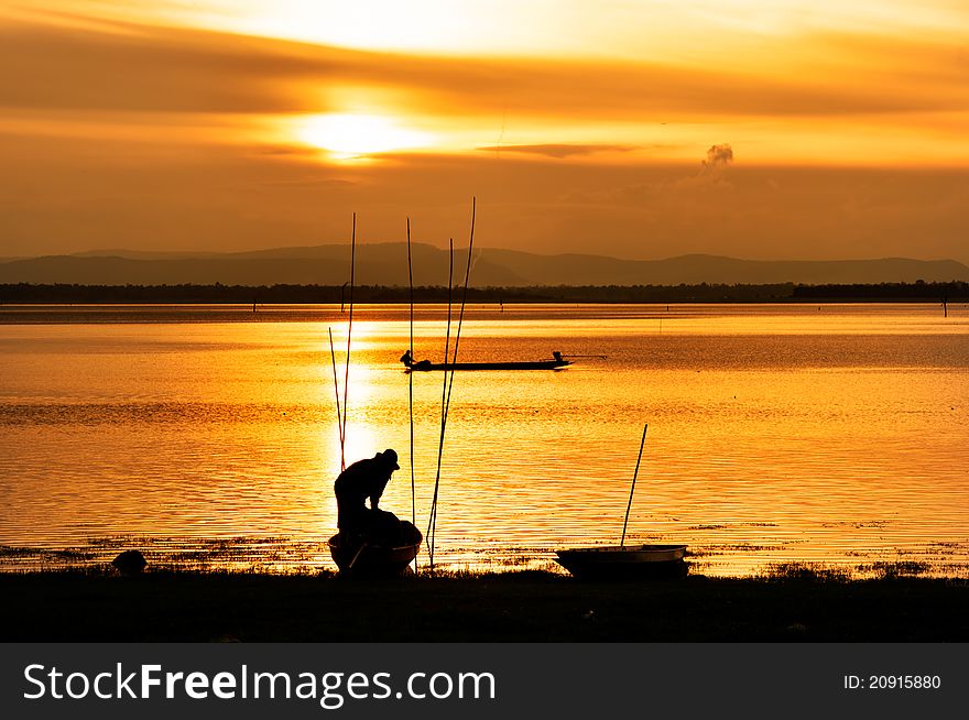 Silhouette of fisherman working in sunset , Thailand. Silhouette of fisherman working in sunset , Thailand