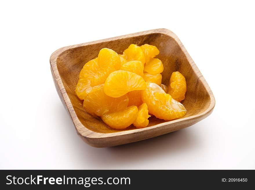 Mandarins peeled and in the wooden bowl