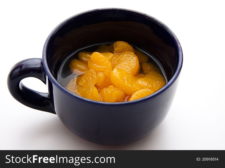 Tangerine peeled in the ceramics cup. Tangerine peeled in the ceramics cup