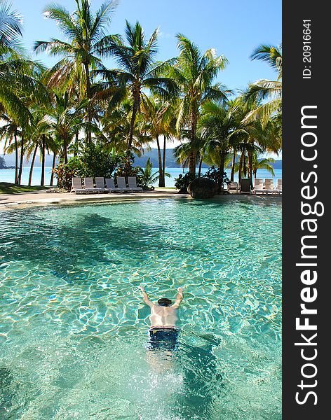 Man swimming under water in pool, tropical resort, Australia