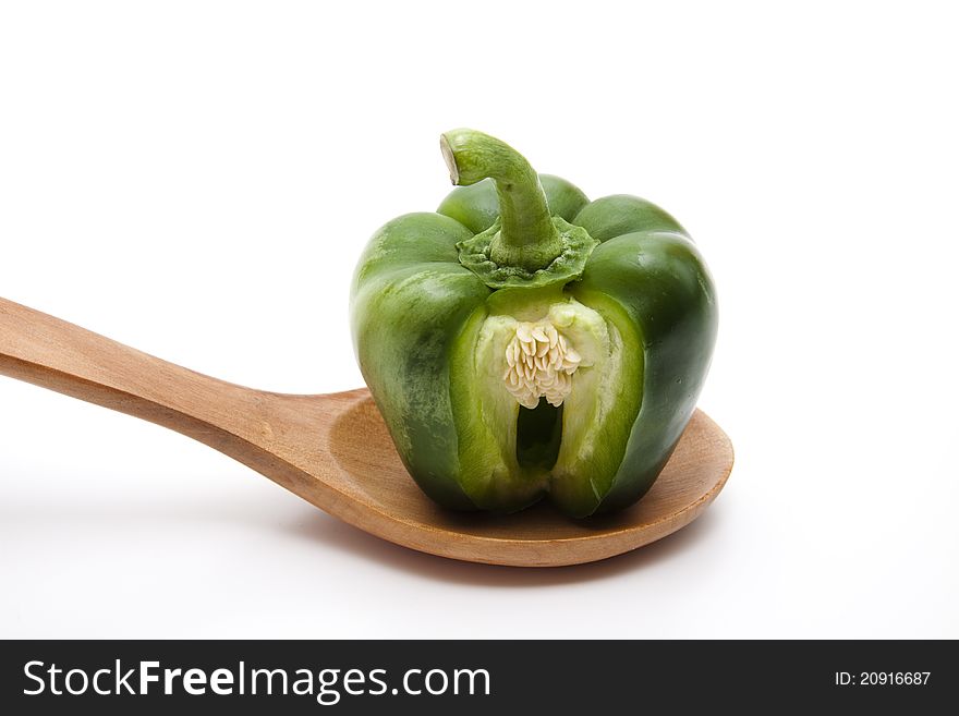 Green paprika on wooden spoon. Green paprika on wooden spoon