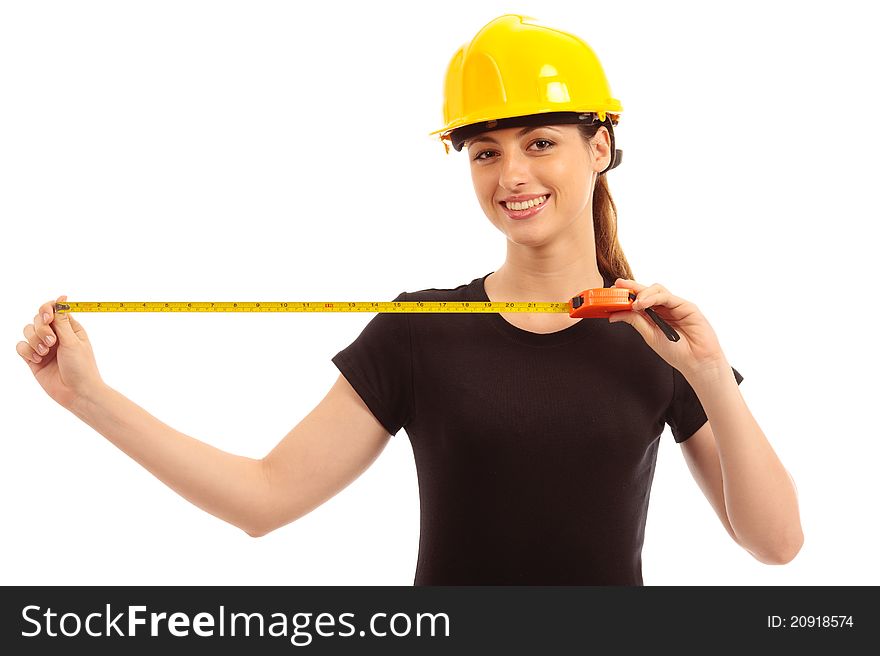 A young female holding a tape measure wearing a safety hat. A young female holding a tape measure wearing a safety hat