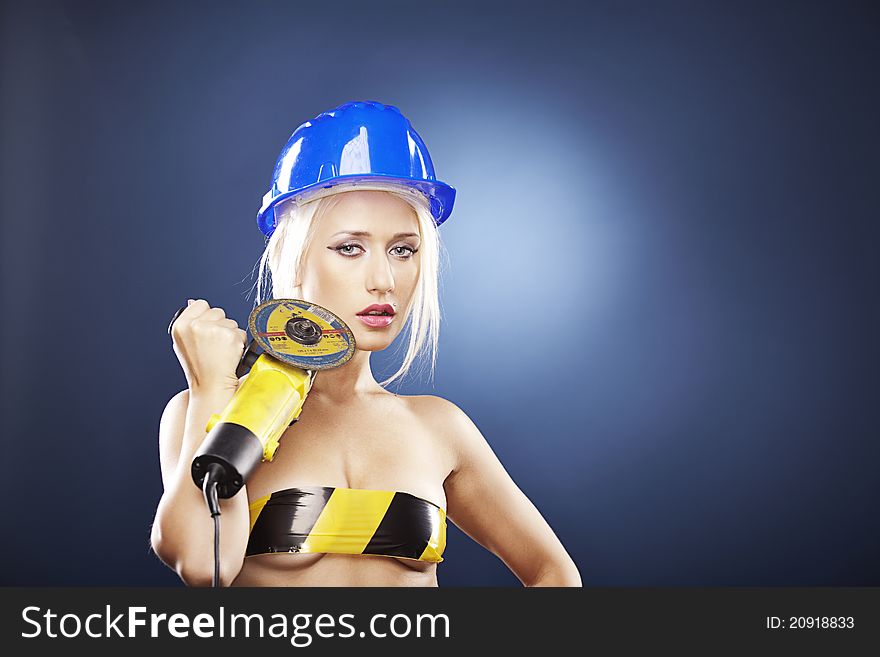 Beautiful blonde model with angle grinder