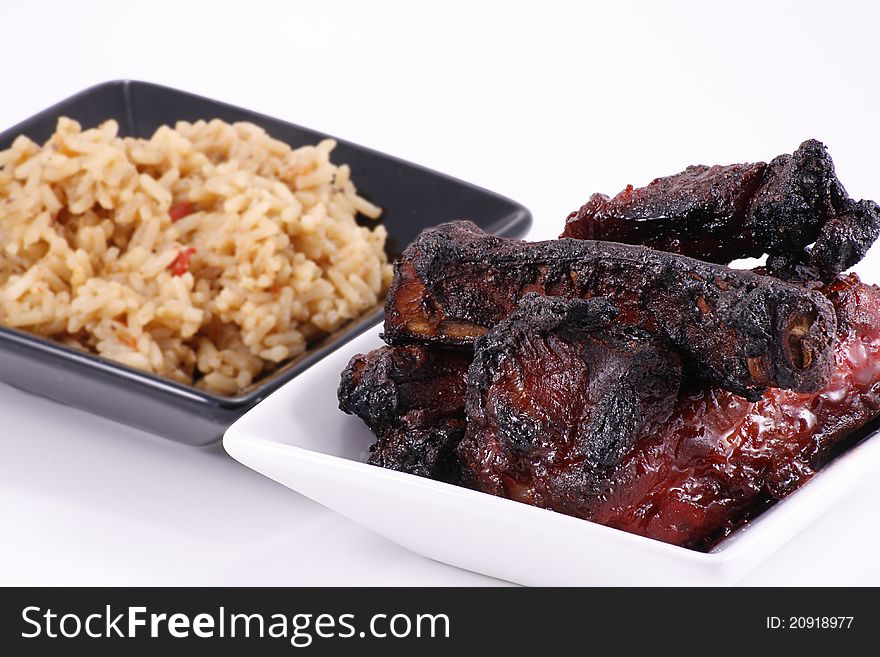 Barbecued chinese pork ribs and rice isolated on white background. Barbecued chinese pork ribs and rice isolated on white background