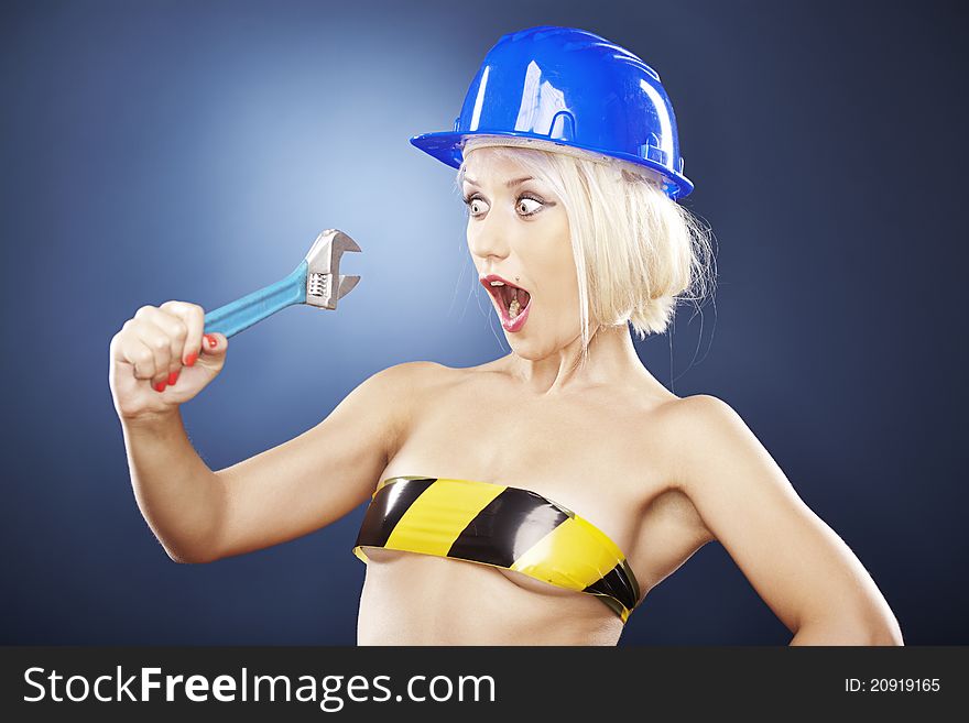 Shocked blonde model with a construction helmet