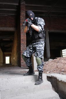 Armed Terrorist In Black Mask Targeting With A Gun Stock Images