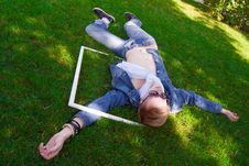 Young Human On The Green Grass With White Frame Royalty Free Stock Images Young Human On The Green Grass With White Frame Royalty Free Stock Images