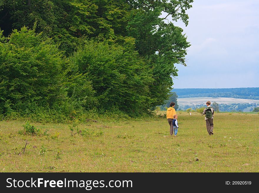 Mother and two sons in the green woods