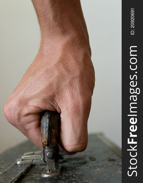 A close-up frontview of a hand, carrying a case. A close-up frontview of a hand, carrying a case