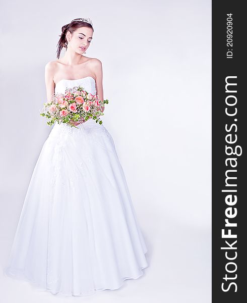 Woman in wedding dress with flowers. Woman in wedding dress with flowers