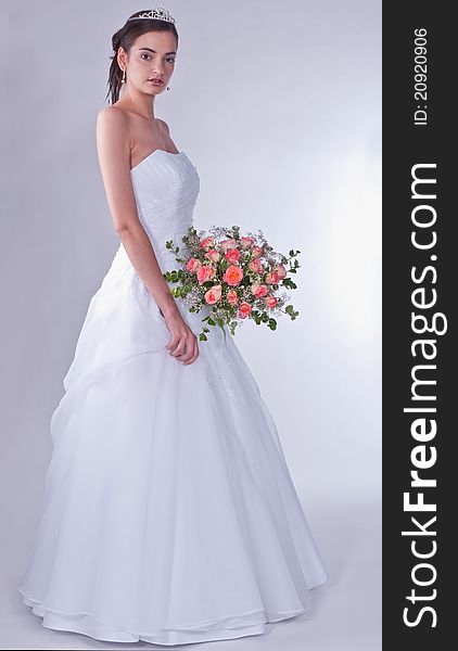 Woman in wedding dress with flowers. Woman in wedding dress with flowers