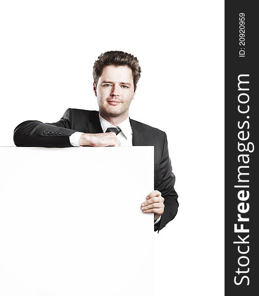 Young businessman holding a blank white board. Isolated on a white background