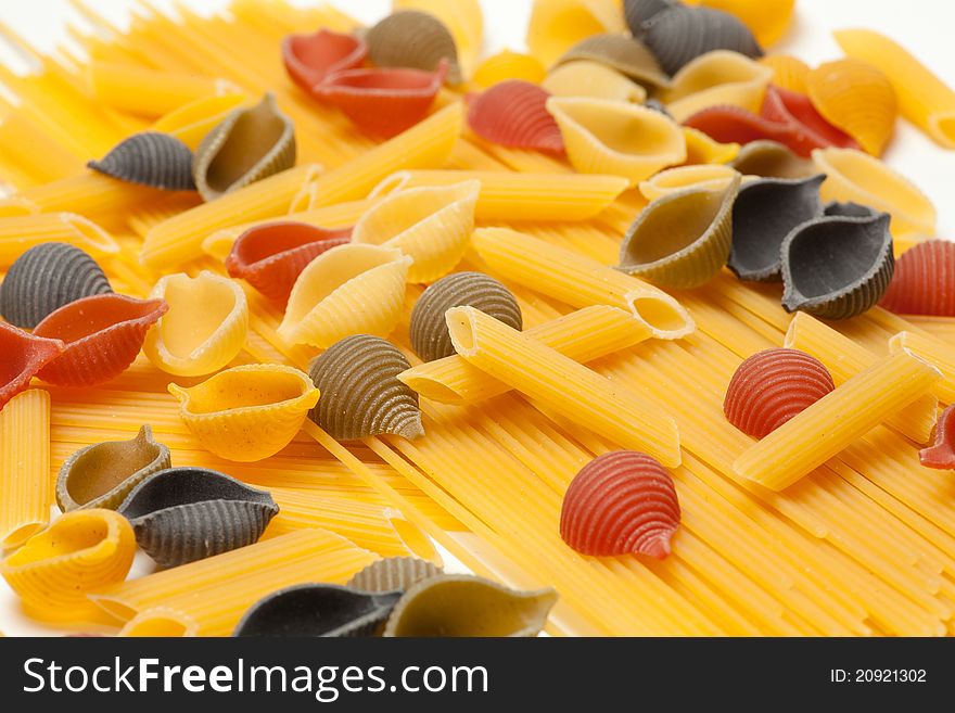 Colorful pasta lying on a bed of spaghtti. Colorful pasta lying on a bed of spaghtti