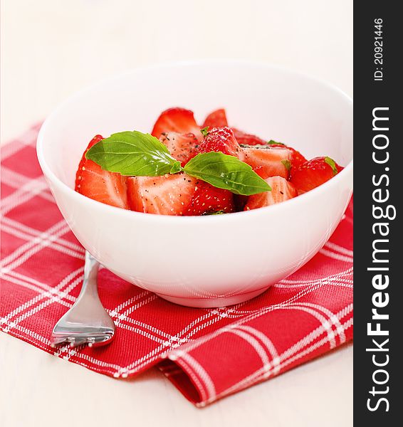 Fresh strawberry salad with basil and pepper