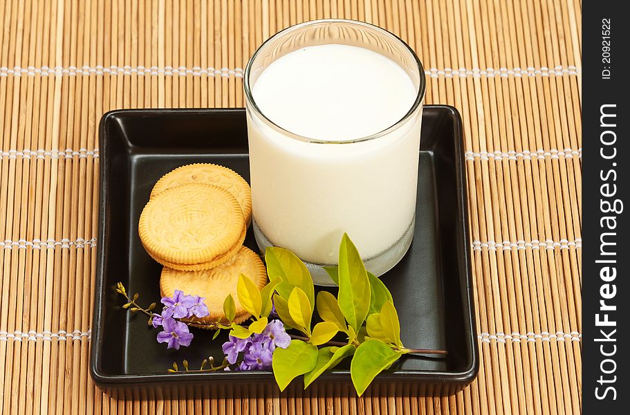 Cookie and milk on bamboo mat