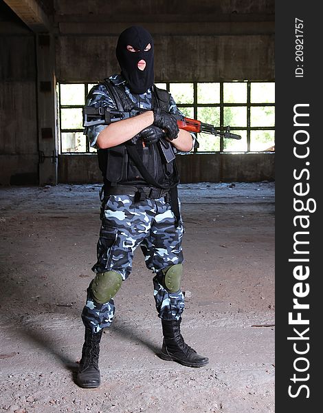 Armed Soldier In Black Mask Hodling A Gun