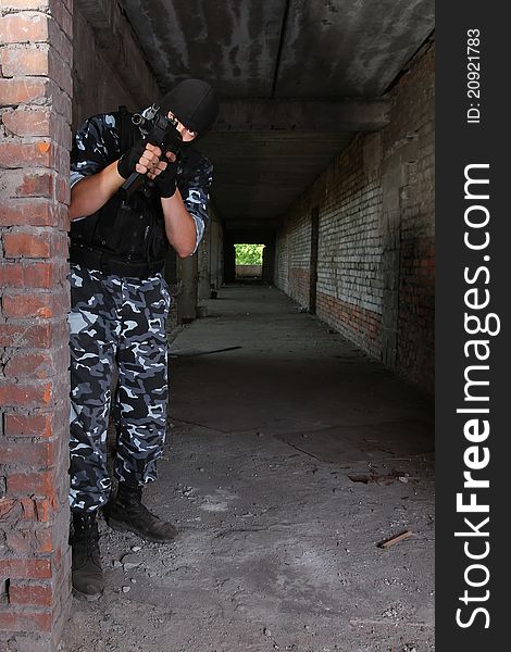 Armed Soldier In Black Mask Targeting With A Gun