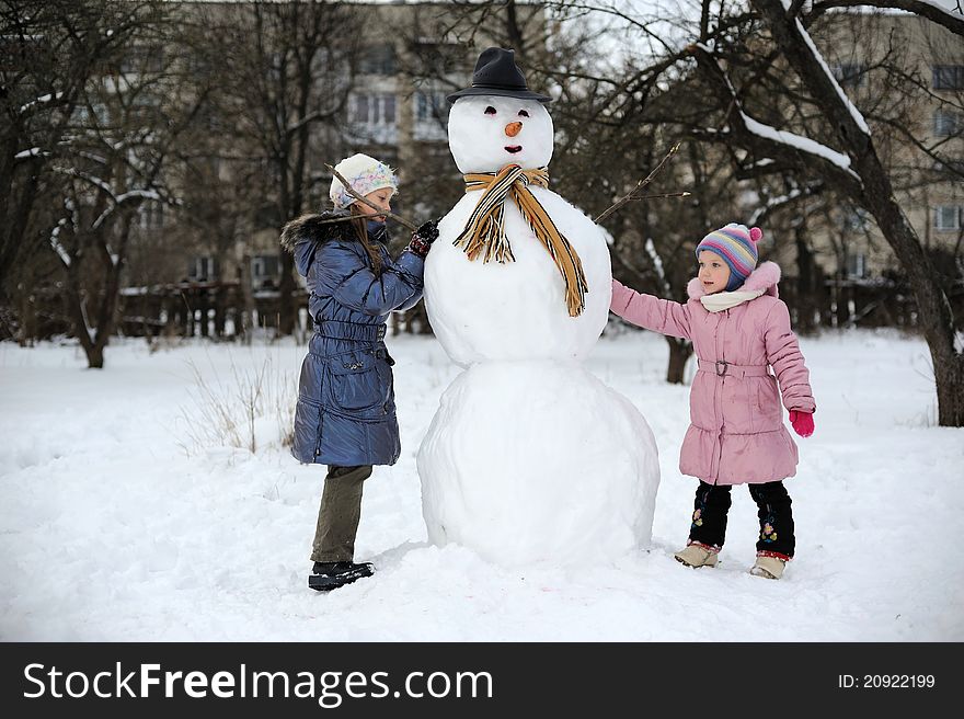 Two little girls are doing great snowmen. Two little girls are doing great snowmen