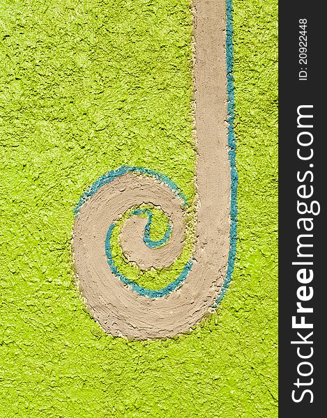 Long spiral decorated on green wall cement in the garden