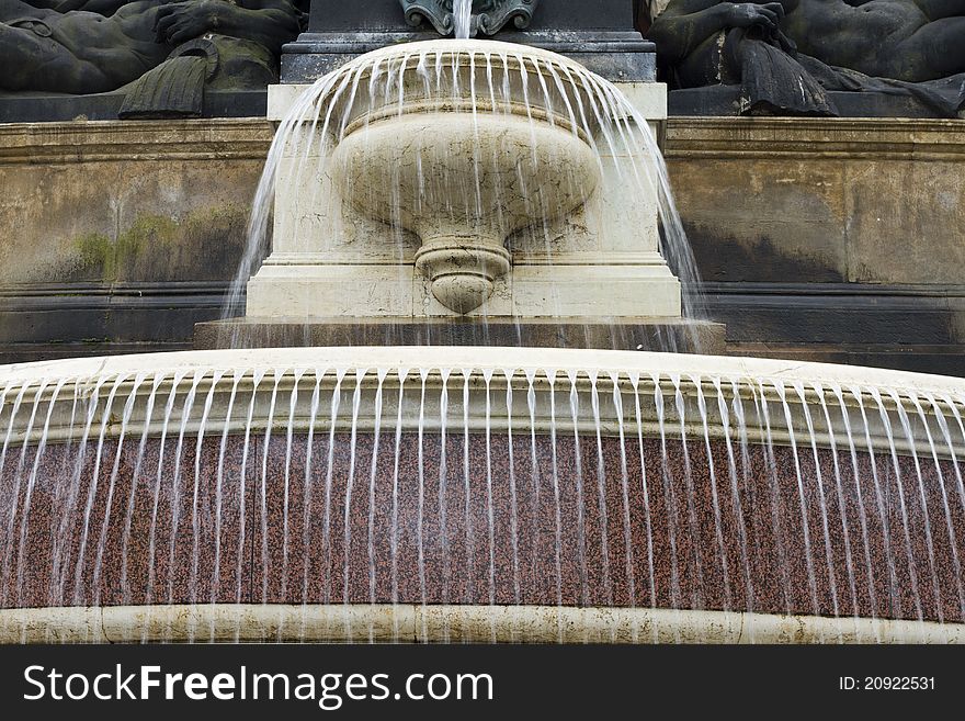 Fountain in flow with statues at the top