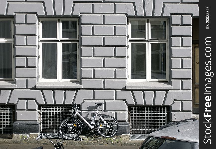 Old city house facade with a bicycle under the Windows. Old city house facade with a bicycle under the Windows.