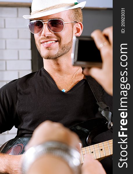 Selective focus on guitar player with fans around. Selective focus on guitar player with fans around.