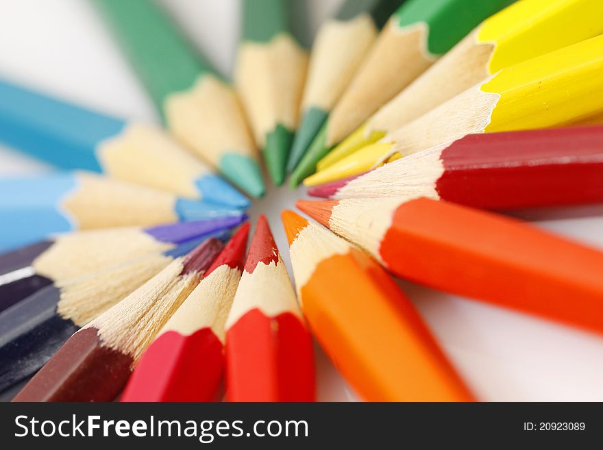 Color pencils in arrange in color wheel colors on white background. Color pencils in arrange in color wheel colors on white background