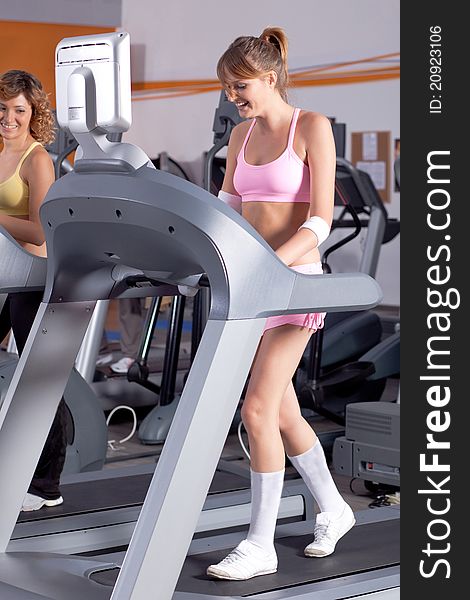 Woman On Running Machine In Gym