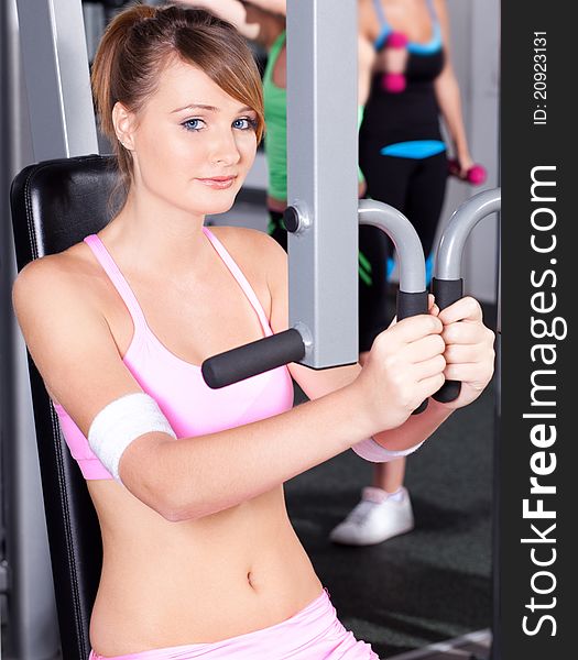 Portrait of young female exercising in gym..