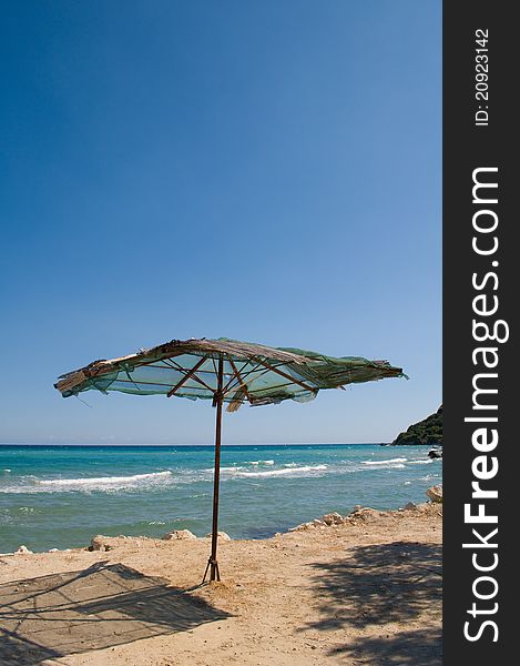 Rusty iron framed sun umbrella on beach. Rusty iron framed sun umbrella on beach