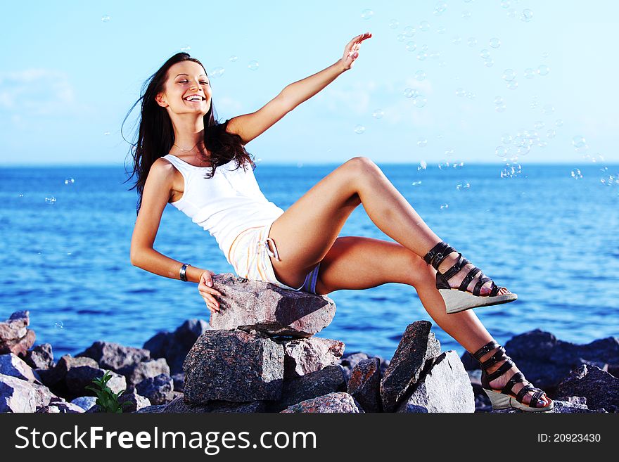 Happy brunette hair woman sea on background. Happy brunette hair woman sea on background