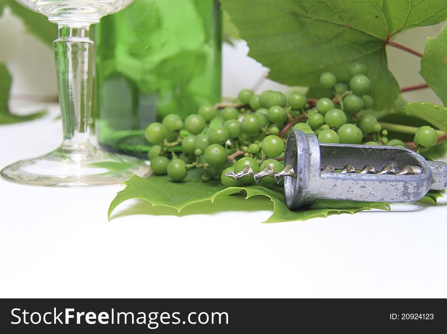 Wine cork, corkscrew and grapes with leaf on white background. Wine cork, corkscrew and grapes with leaf on white background