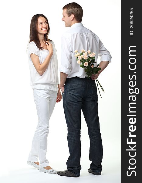 Romentic date: guy presenting flowers to young lady; white background