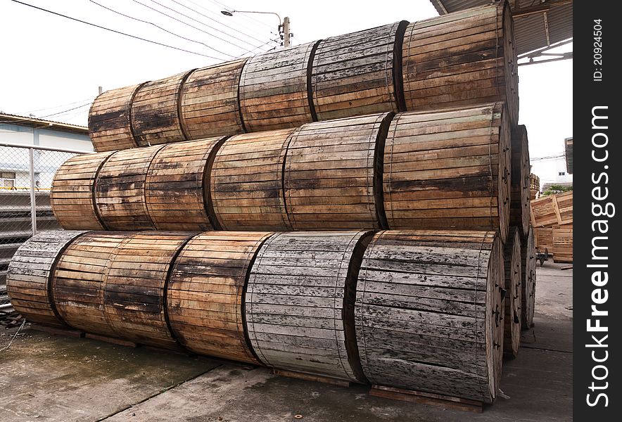 Pile of wooden electric wire reels in stockpile for distribution tilted out. Pile of wooden electric wire reels in stockpile for distribution tilted out