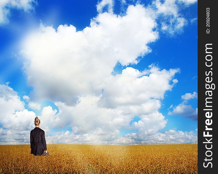 woman wearing black coat, standing  on field. woman wearing black coat, standing  on field