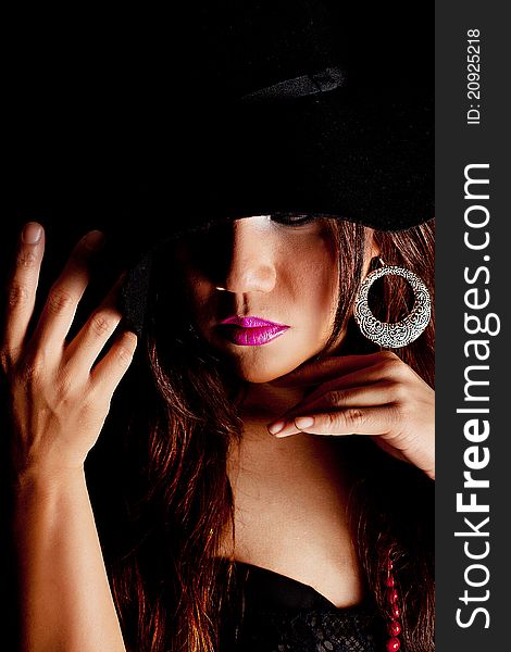 Close up wearing a black hat with dramatic lighting