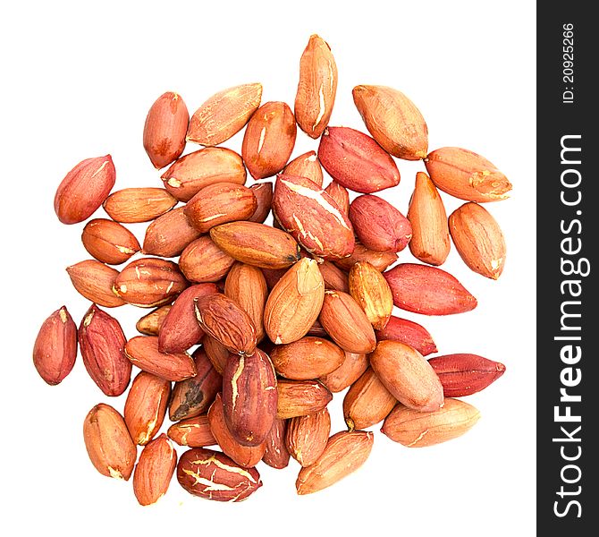 Pile of peanuts with skin isolated on white.