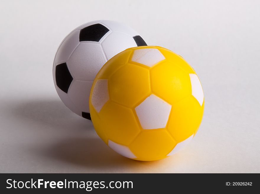 Black and yelow toy soccer ball on white background