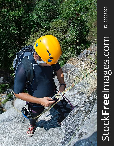 Men prepering to rappeling on waterfall checking is safe line and securety. Men prepering to rappeling on waterfall checking is safe line and securety