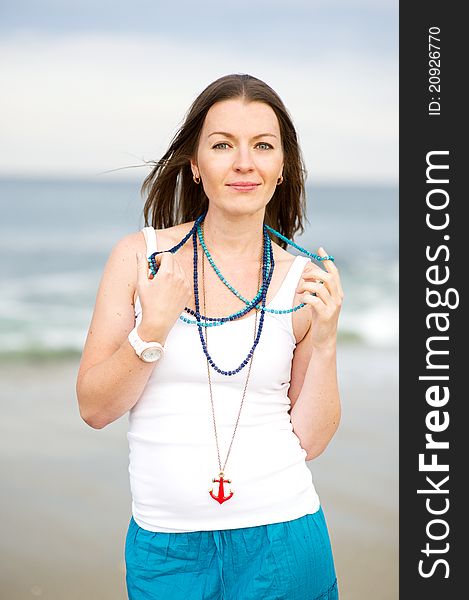 Portrait of a beautiful brunette woman with a necklace. Portrait of a beautiful brunette woman with a necklace