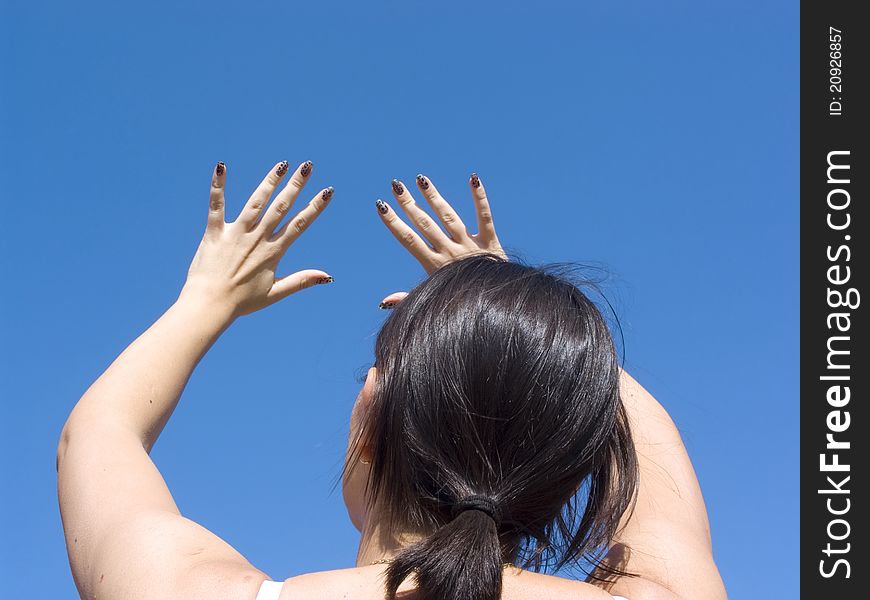 The girl with black hair, stretching his hands toward heaven. The girl with black hair, stretching his hands toward heaven