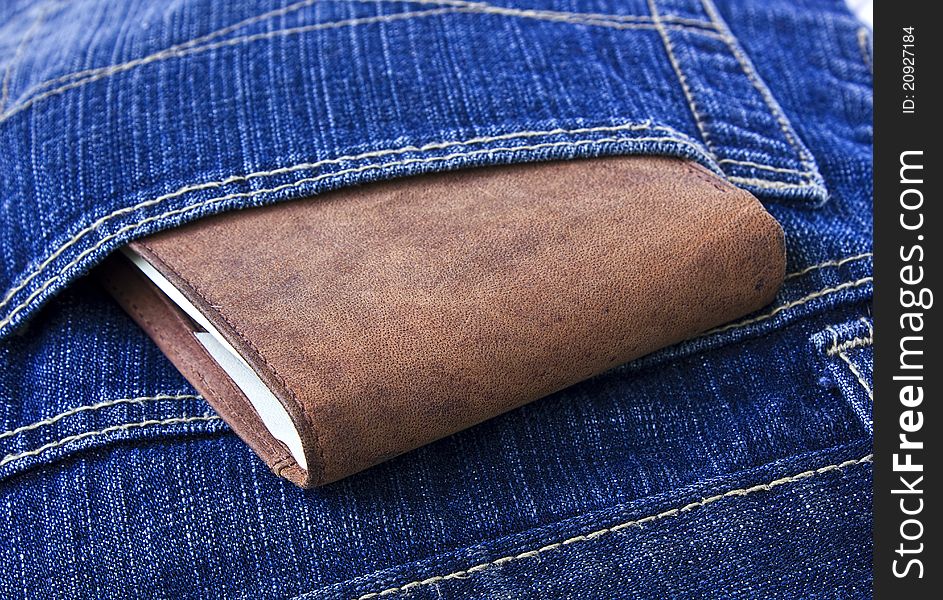 Leather Wallet With Money In Blue Jeans.