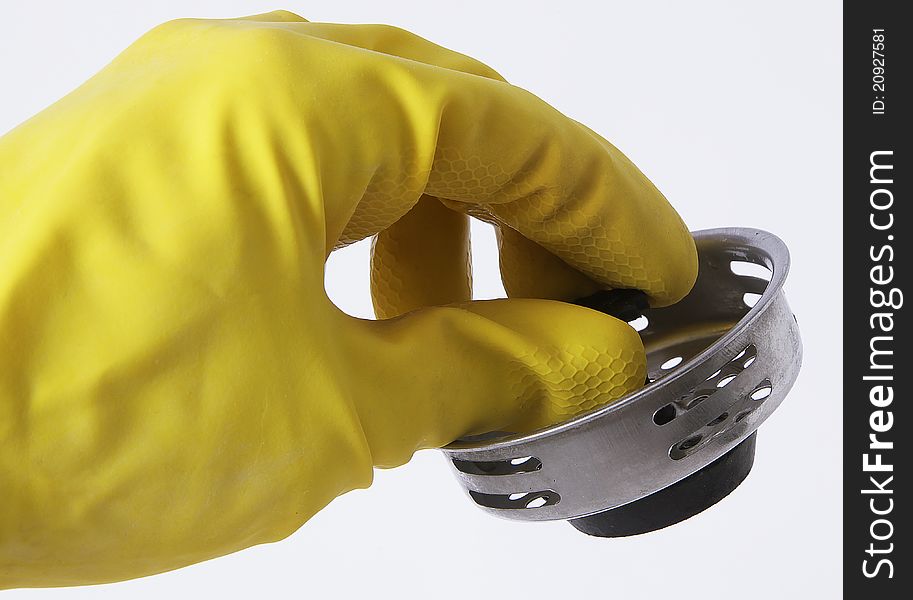 Yellow rubber glove holding a stopper for a sink. Yellow rubber glove holding a stopper for a sink.