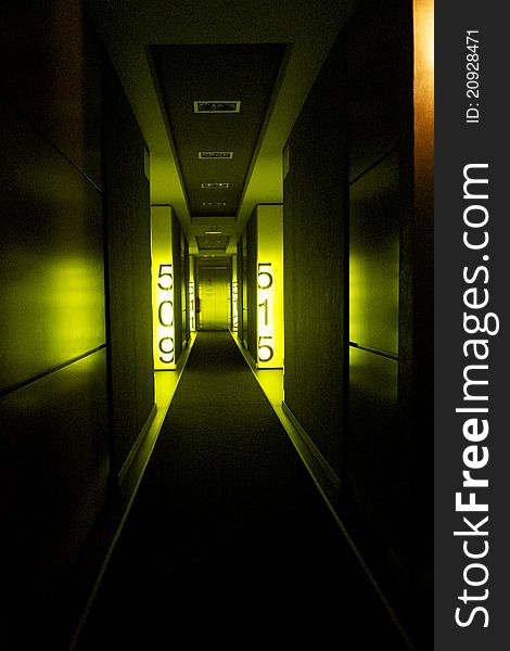 Dark indoor corridor illuminated with green lights